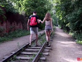 Boy and chick walk on railroad before humping