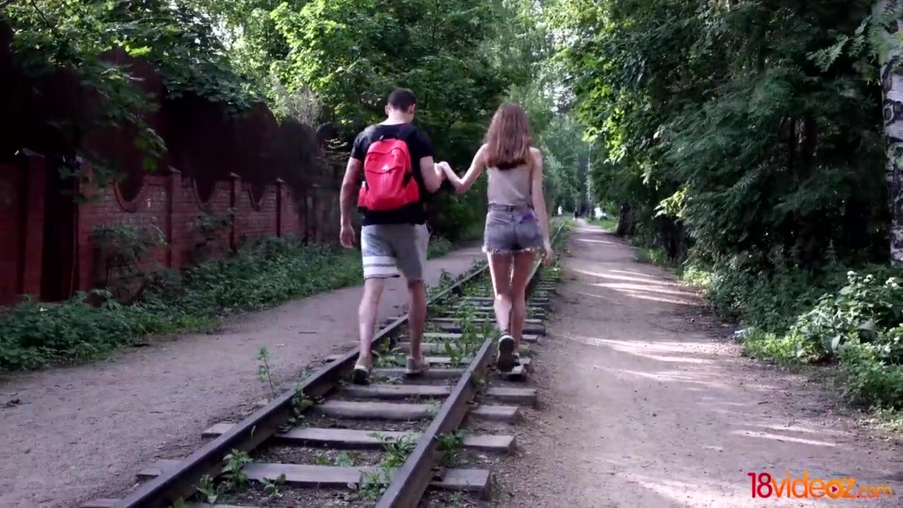 Boy and chick walk on railroad before humping