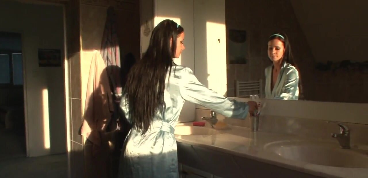 Chick misuses electric toothbrush in the bathroom
