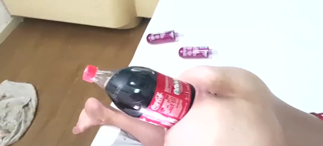 Big soda bottle is penetrating her tight asshole