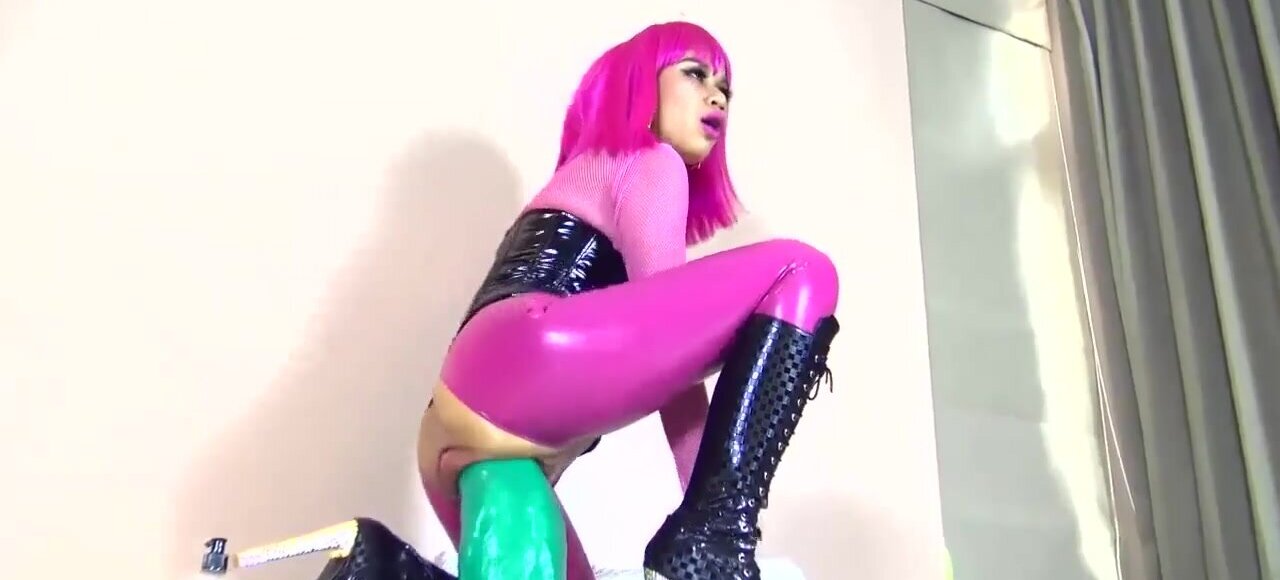 Perverted amateur wears a latex suit and rides a big toy