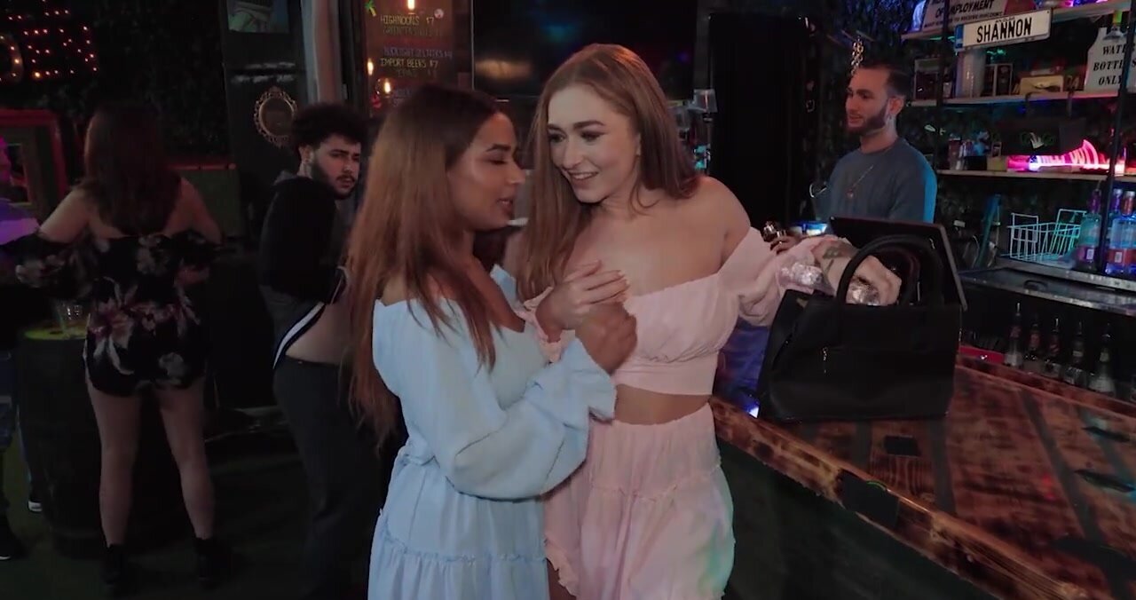 Two lesbians are playing with a toy and a real penis