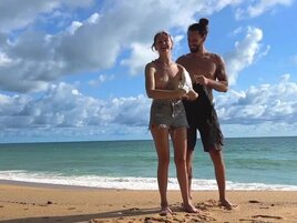 Tattooed hottie and her partner are naked on the beach