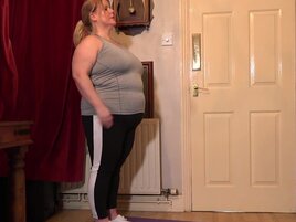 Fat lady showing off her body during a yoga workout