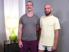 The shorter fellow is ready to top the lad with a moustache