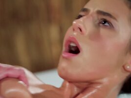 Oiled-up brunette is going to get fucked silly